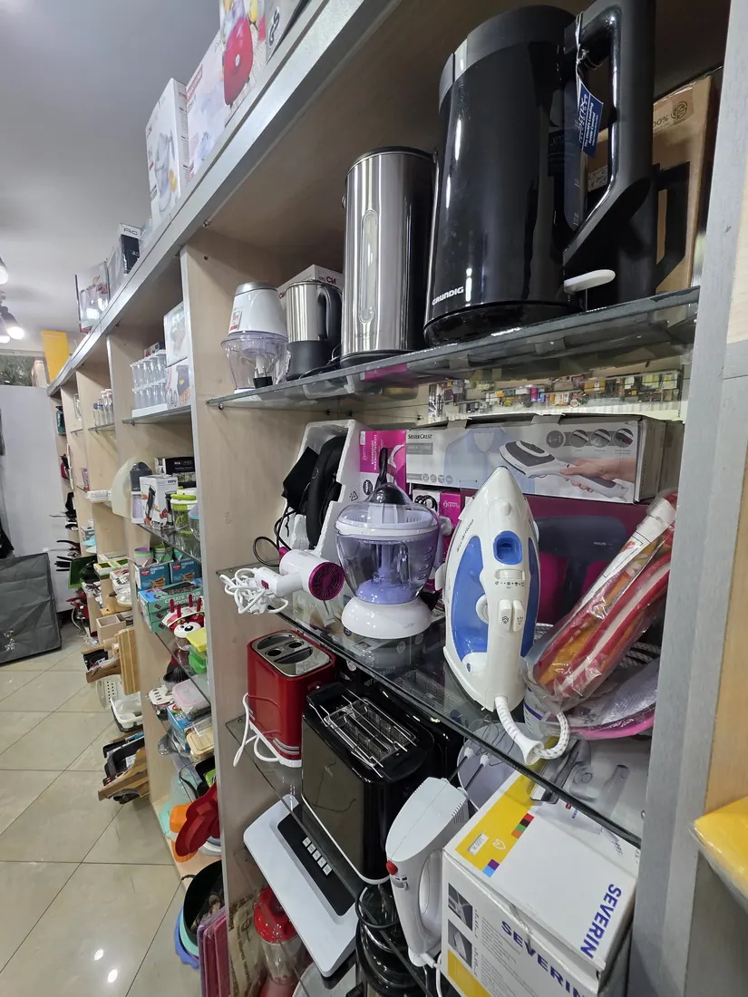 Electric kettles, toasters and irons on the shelf